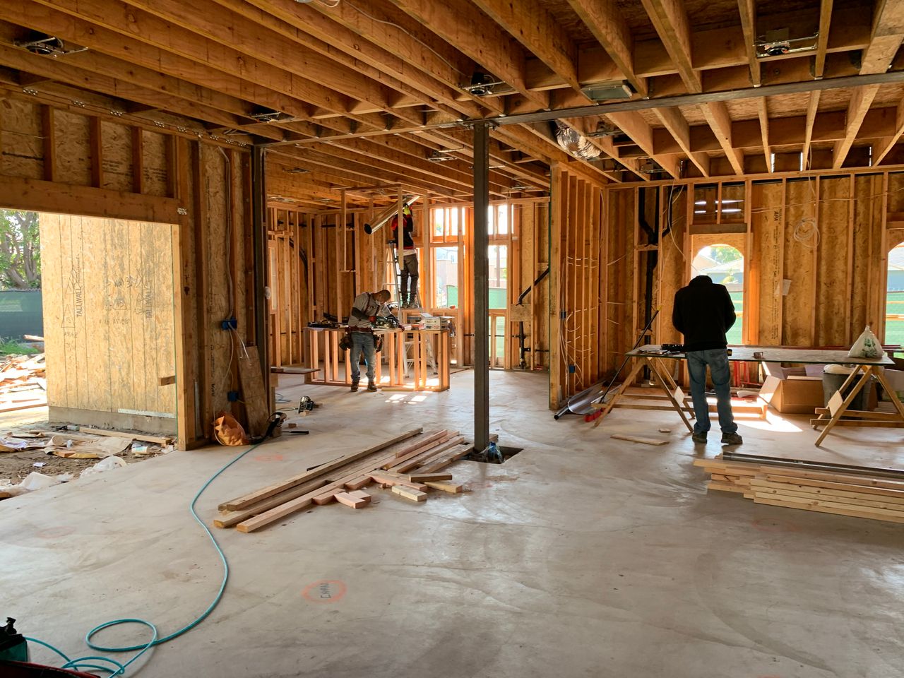 Crafting Captivating Headlines: Your awesome post title goes here Workers constructing a house framework, showcasing interior carpentry and building process.
